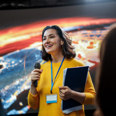 woman speaking at conference with colorful graphic 2026 03 26 10 38 10 utc